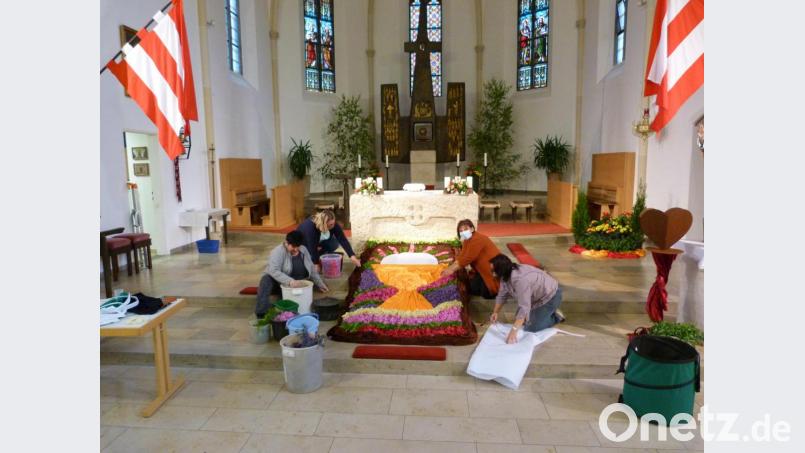 Eine Fleißaufgabe in Zeiten von Corona: Frauen aus dem Pfarrgemeinderat legen einen Blumenteppich im Altarbereich der Manteler Kirche. Bild: hok