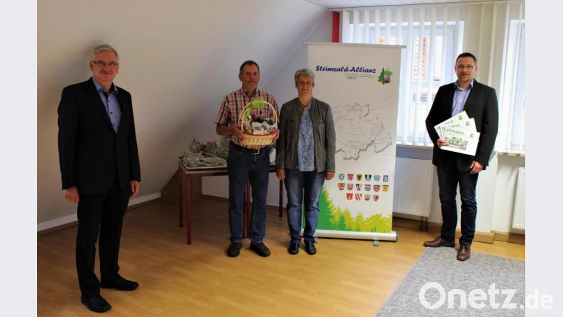 Martin Schmid (rechts), Geschäftsführer der Steinwald-Allianz, und Vorsitzender Johannes Reger (links) überreichten den Gewinn an Anette und Norbert Philipp (Mitte). Bild: ckl