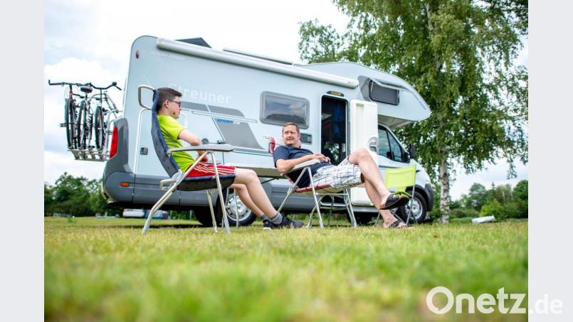 Urlauber aus Bayern sitzen auf einem Campingplatz vor ihrem Wohnmobil. Foto: Hauke-Christian Dittrich/dpa/Archivbild Bild: Hauke-Christian Dittrich