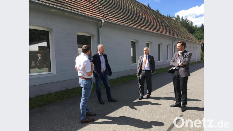Bürgermeister Thomas Meiler erläutert Erik Bergner und Thomas Gollwitzer vom Amt für Ländliche Entwicklung sowie Landtagsabgeordnetem Stephan Oetzinger vor dem historischen Dampfwerksgebäude die Industriegeschichte Altenhammers. Bild: cro