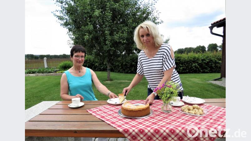 Kerstin Schraml serviert ihrer Schulleiterin, Doris Eckl, im idyllischen Garten der Neumühle einen leckeren Käsekuchen. Kuchen und Torten sind Schramls Spezialität. &quot;Und ich hatte Glück in der praktischen Prüfung, weil das Thema Backen zu meinen Aufgaben gehörte&quot;, freut sie sich. Bild: ubb