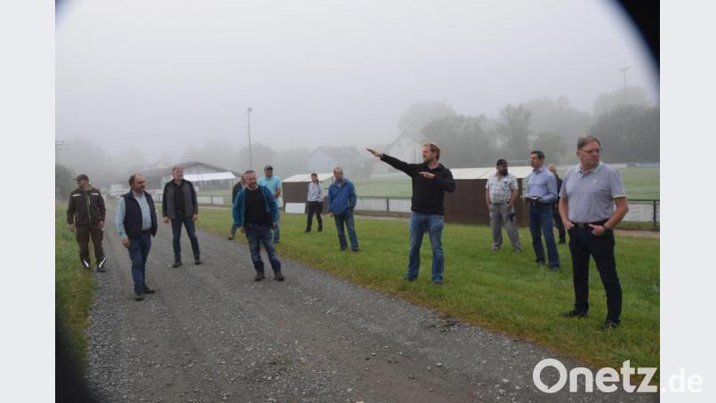 Zweiter Bürgermeister Andrian Blödt zeigt zum Hang oberhalb des Sportplatzes. Von hier kommen zum Großteil die Abschwemmungen bei Starkregen. Bild: fz