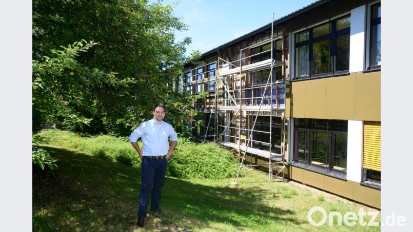 Die noch vorhandene Außenfassade zeigt in Verbindung mit den bereits abgebauten Teilen, dass seinerzeit beim Bau der Grundschule eine heutzutage übliche Wärmedämmung nicht erwogen wurde. Deshalb ist Bürgermeister Sebastian Hartl jetzt froh, dass die energetische Sanierung abgewickelt werden kann. Bild: bey