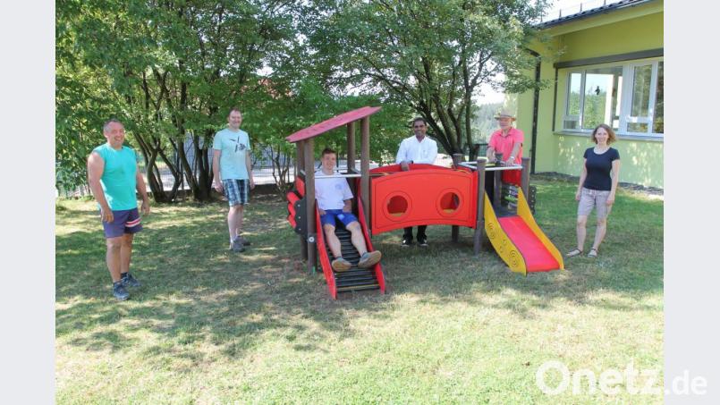 Markus Woppmann darf als Jüngster schon mal als Tester fungieren. Über das neue Spielgerät freuen sich außerdem Arnold Woppmann, Bernhard Lang, Pfarrer Julius Johnrose, Josef Meckl und Anja Thalhauser (von links). Bild: pi