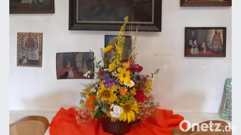 Hammricher Frauentag: Sonnenblumen vor den Votivtafeln im Hammerkirchl. Bild: gis