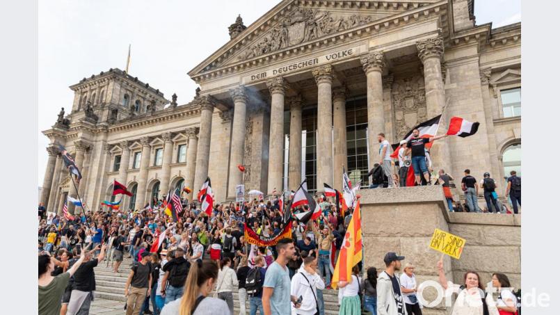 Zum ersten Mal seit 75 Jahren: Schwarz-weiß-rote Fahnen werden am Zugang zum Reichstag geschwenkt. Bild: Achille Abboud