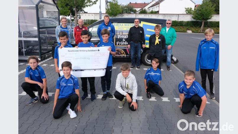 Spendenübergabe im Edeka-Markt an der Pfistermeisterstraße (hinten, von links) Laura Mois vom SV Raigering, Alfred Scherm vom SC Germania Amberg, Stefan Ottmann vom SV Raigering, Firmeninhaber Manfred Wiesmeth, Marktleiterin Signore Wittmann und Ewald Vater vom FC Schlicht. Bild: usc