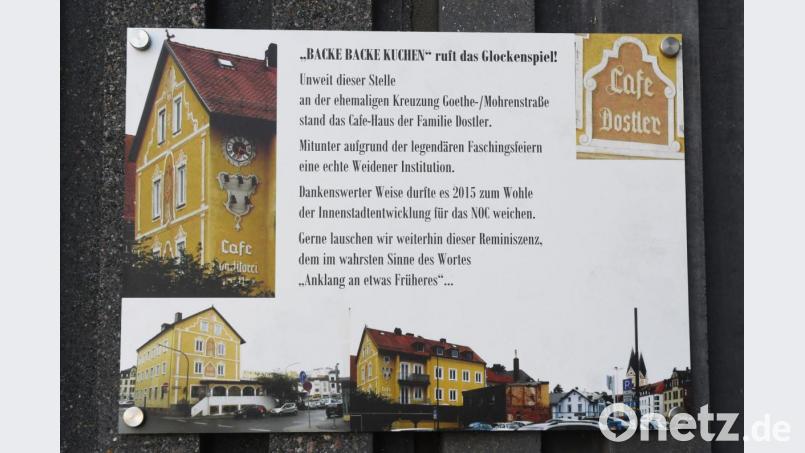 Eine Hinweistafel erinnert unterhalb des Glockenspiels an der NOC-Fassade an die Historie. Bild: Gabi Schönberger