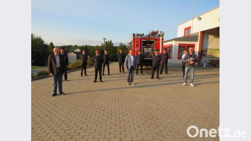 Bürgermeister Karlheinz Budnik (vorne, Mitte) und Feuerwehrreferent Thomas Wilhelm (vorne, links) übergaben die neue Ausrüstung an die Kommandanten der Feuerwehren. Wasserwart Sebastian Plödt (vorne, rechts) präsentierte den Systemtrenner, der maßgeblich zum Trinkwasserschutz bei Einsätzen beiträgt. Bild: adj