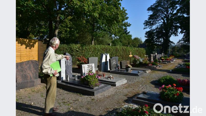 Georg Raithel deutet auf die Stelle, wo vor 75 Jahren eine Bombe im Stadtfriedhof explodierte. Noch heute ist die Vertiefung sichtbar. Bild: shl