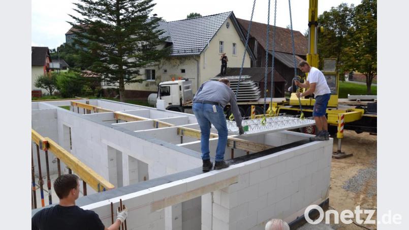 Ein Gerätehaus in Eigenregie: Unterstützung erhalten die Feuerwehrler unter anderem aber von der Firma Lindner, die die 1,5 Tonnen schweren Platten mit dem Autokran auf das neue Gerätehaus hievte. Bild: gi