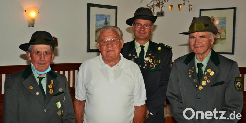 Willi Aures (links), Schützenmeister Helmut Sperber (Dritter von links) und Hans Sperber (rechts) gratulieren Peter Grünthaler zum 90. Geburtstag. Bild: ker
