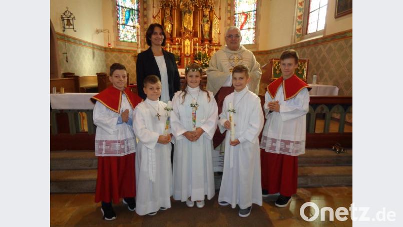 Pfarrer Eugen Wismeth mit Rektorin Christine Losch und den Erstkommunikanten Benjamin Götz, Lina Schafbauer und Daniel Kiener (von links). Bild: amö