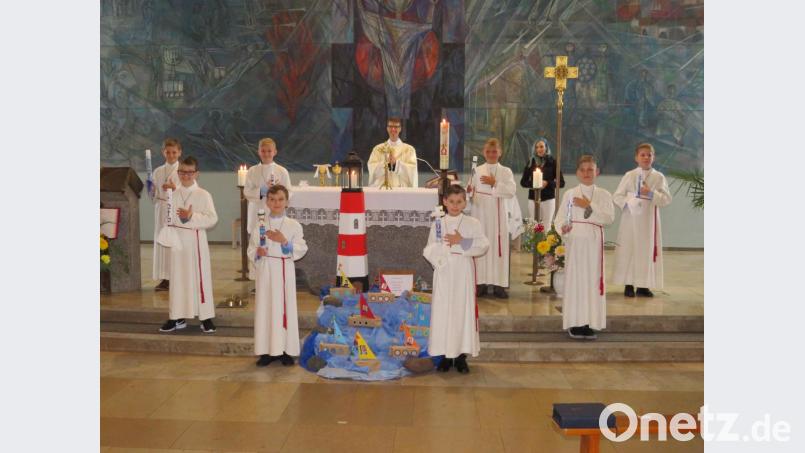 Nach dem Gottesdienst stellten sich die Kommunionkinder mit Pfarrer Thomas Kopp (hinten, Mitte) und Gemeindereferentin Birgit Lang-Riebl (hinten, rechts) rund um den Leuchtturm zum Erinnerungsfoto auf. Bild: adj
