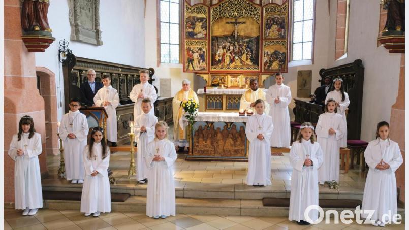 Einen festlichen Gottesdienst feiern die 13 Erstkommunionkinder der Pfarrei St. Laurentius mit Stadtpfarrer Thomas Jeschner (hinten, Mitte), Pfarrvikar Gerald (hinten, rechts) und Pastoralreferent Alfred Kick (hinten, links). Bild: do