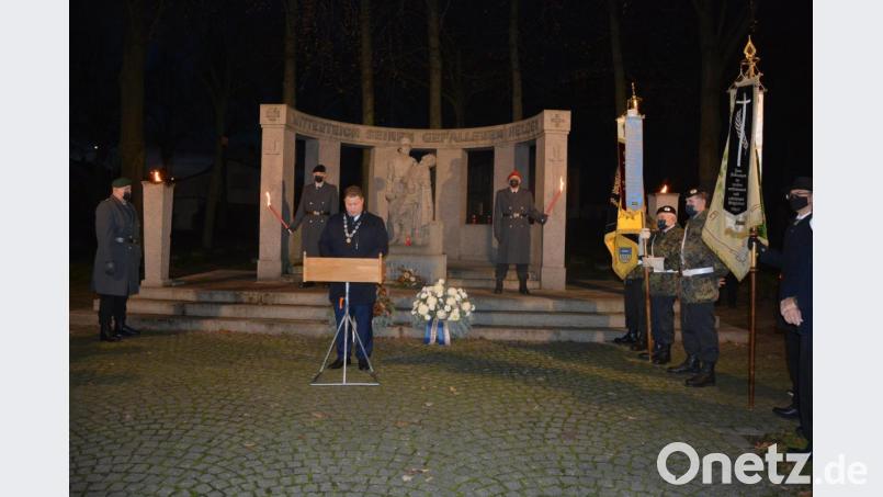 Bürgermeister Stefan Grillmeier am Mitterteicher Kriegerdenkmal mit der Ehrenwache und den Fahnenabordnungen der Vereine. Bild: jr