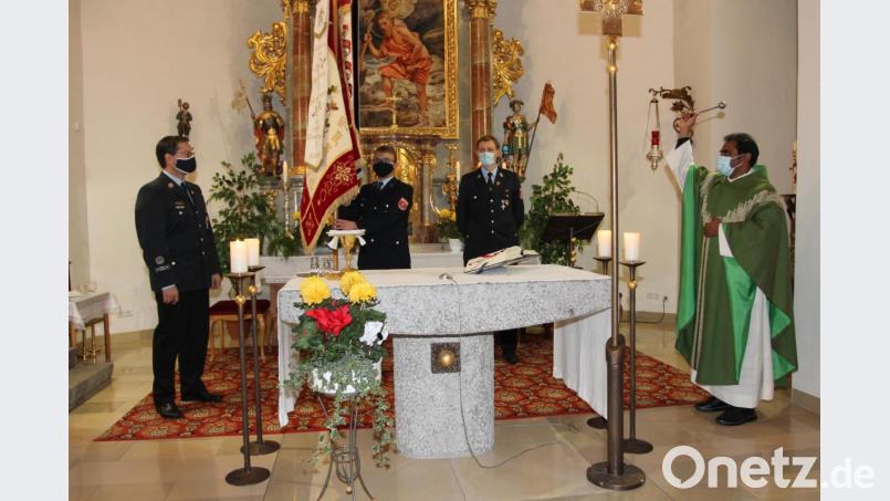 &quot;Ich bitte Gott um seinen Schutz und Segen während ihres Einsatzes zum Wohle unserer Mitmenschen&quot;, sagt Pfarrer Julius Johnrose bei der Segnung der von Niklas Krapf gehaltenen restaurierten Fahne. Das erhoffen sich auch die Vorsitzenden Achim Helgert und Stefan Frischholz (von links). Bild: pi