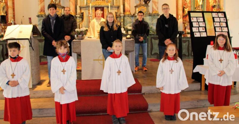 Pfarrer Werner Sulzer (hinten Mitte) verabschiedet fünf Ministranten und nimmt bei dieser Gelegenheit fünf Neulinge in die Schar der Messdiener in der Pfarrei Schmidmühlen auf. Bild: bjo