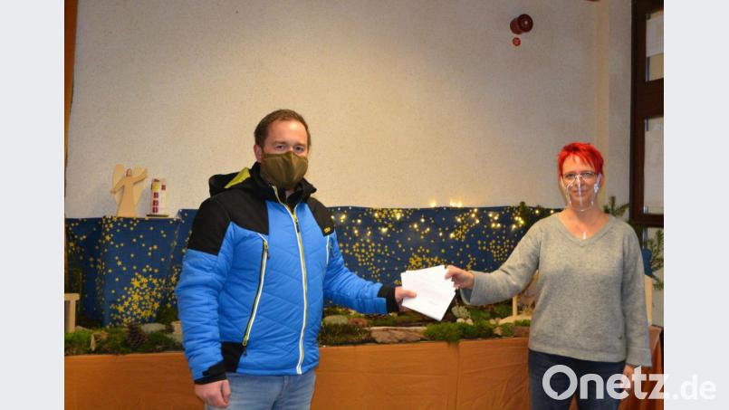Christian Kneidl vom Elternbeirat übergibt die Spende an die Kindergartenleiterin Barbara Krauthahn. Bild: xs