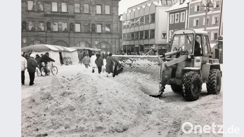 Winter im Februar 1991 in Amberg: Ein Räumfahrzeug schiebt auf dem Marktplatz Schneeberge zusammen. Archivbild: ref