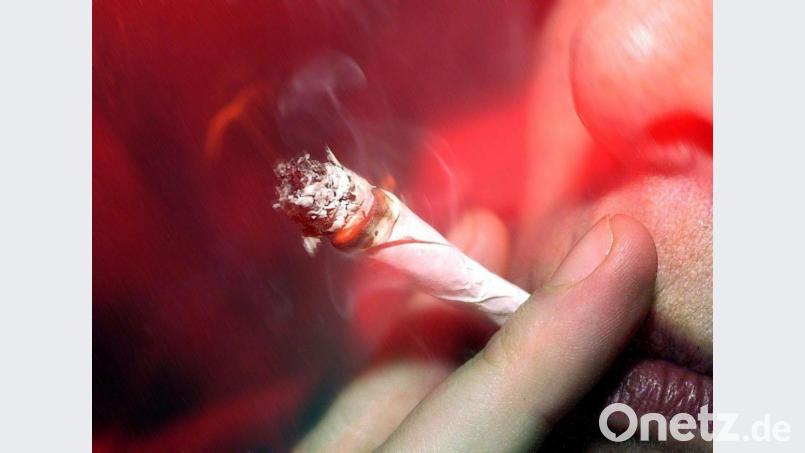 Eine Cannabis-Konsument zieht an einem Joint. Bild: Torsten Leukert/dpa