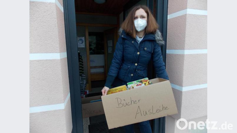Auch wenn Besuche der Bücherei derzeit nicht möglich sind, besteht die Möglichkeit, sich mit Lesestoff einzudecken. Die Mitarbeiterinnen stellen nach den Wünschen der Leser Überraschungspakete zusammen. Hier präsentiert Eva Gruber ein solches. Bild: Anita Benkhardt/exb