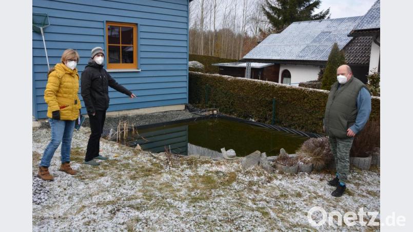 Isgard und Lars Forschepiepe (von links) stehen neben ihrem Gartenteich, in dem es sich den ganzen Dienstag über ein Biber gemütlich gemacht hatte. Am Mittwochmorgen wollte Biberberater Horst Fischer eingreifen, doch das Tier war wieder verschwunden. Bild: jr
