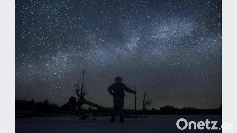 Dave Cooke beobachtet die Milchstraße über einem gefrorenen Fischschutzgebiet in der kanadischen Provinz Ontario. Bild: picture alliance/dpa/Fred Thornhill