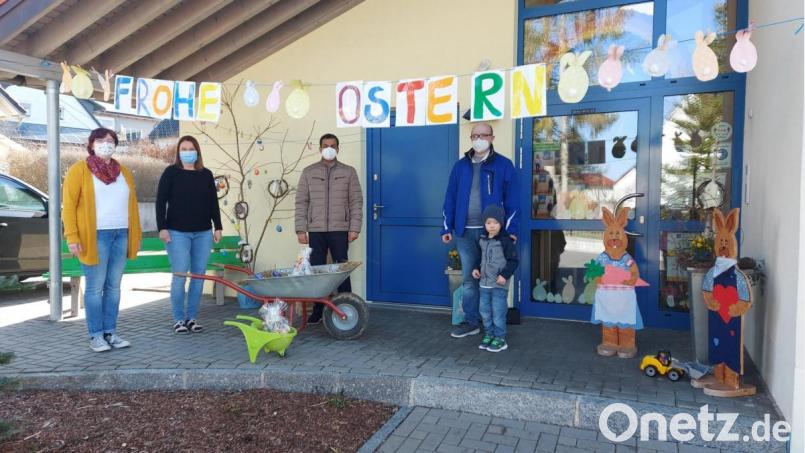 Kinderhausleiterin Bianca Kastner (von links), Stellvertreterin Sandra Lautner, Pfarrer Pater Anish George sowie Kirchenpfleger Stefan Kausler mit Sohn Fabian freuen sich über das Ostergeschenk. Bild: soj