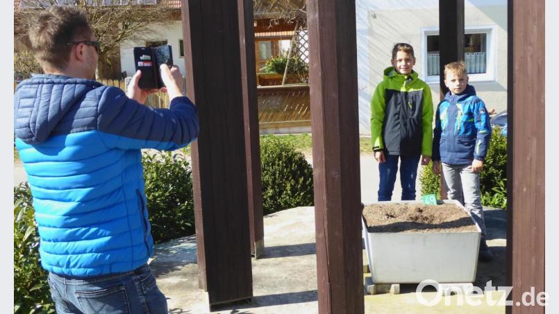 In Hochdorf am Glockenturm fündig geworden: Die beiden jungen Sucher haben schon 26 Täfelchen gefunden. Bild: fsb