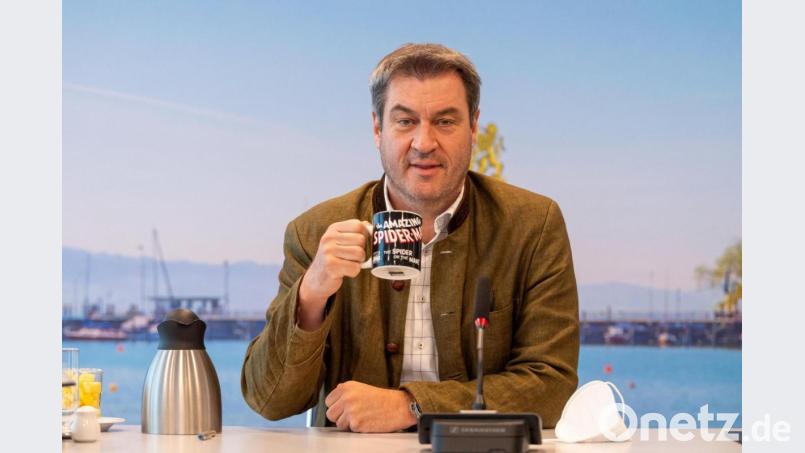 Ministerpräsident Markus Söder (CSU) zu Beginn der Sitzung des bayerischen Kabinetts, die als Videokonferenz geführt, mit einer Tasse in der Hand auf seinem Platz. Bild: Peter Kneffel/dpa