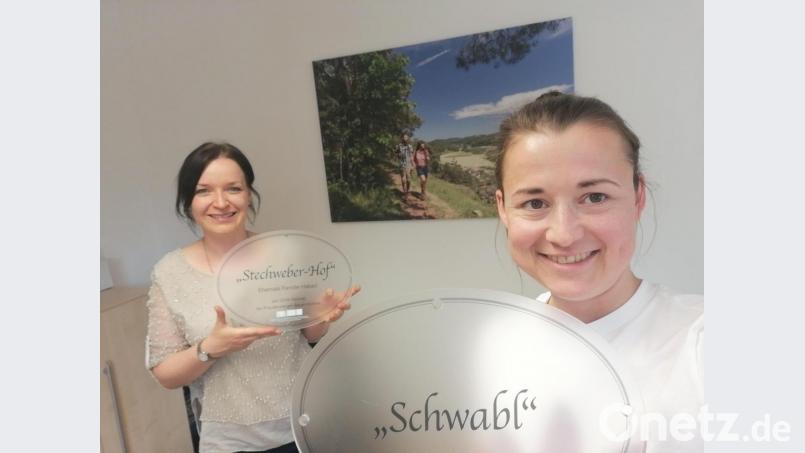 So sehen die Tafeln aus: Veronika Schmalzl (rechts) und Kollegin Melanie Altas von der LAG Amberg-Sulzbach präsentieren die neuen Hausnamenschilder. Bild: Veronika Schmalzl