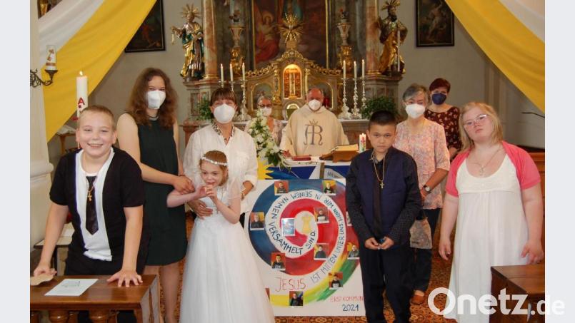 Erstmals an den Tisch des Herrn traten weitere vier Kinder aus der Schule des HPZ Irchenrieth. Gut vorbereitet wurden sie auf ihre Erstkommunion von (hinten, von links) Veronika Kratschmann, Roswitha Jobst, Eva Wagner, Pfarrer Alfons Forster, Rita Faget aus der Tagesstätte und Schulleiterin Petra Rothmund. Fürs Foto setzten die Erstkommunikanten ihre Masken ab, da sie alle geimpft sind. Bild: grm