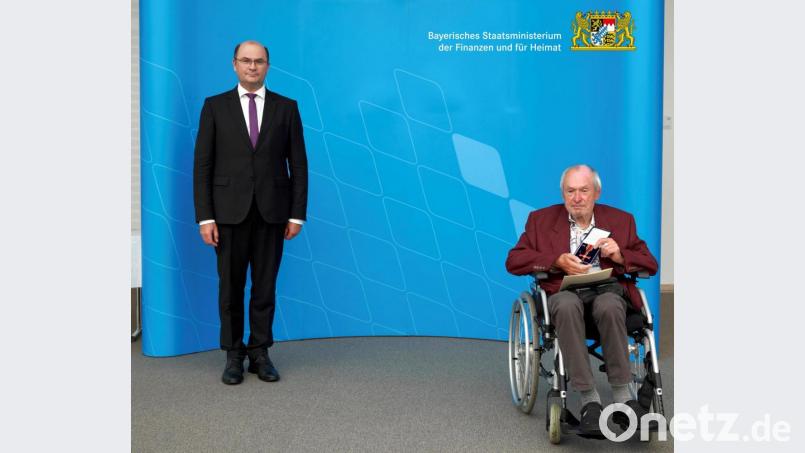 Heimatminister Albert Füracker (links) überreichte das Bundesverdienstkreuz am Bande an Norbert Hagen. Bild: Bayerisches Staatsministerium der Finanzen und für Heimat/exb