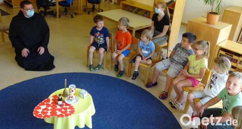 Pater Michael (links) beantwortete gerne die vielen Fragen der Kindergartenkinder. Bild: fks