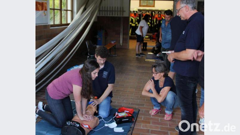 Wolfgang Rattai (rechts) beobachtet die Anwendung des Defibrillators bei einer Wiederbelebung an der Übungspuppe. Das Gerät gibt dem Benutzer per Sprachsteuerung Hinweise zur Vorgehensweise und zur richtigen Platzierung der Elektrokontakte am Körper des Patienten. Bild: ds