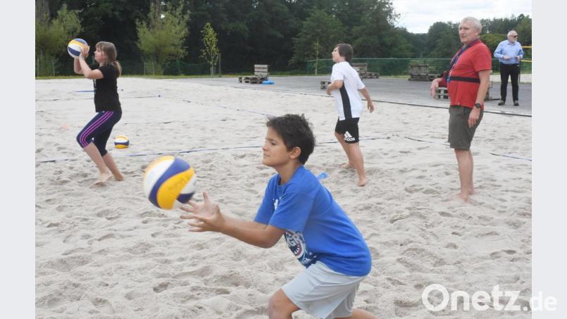 Roland Tschannerl vom Turnerbund Weiden erklärt den Kindern beim Ferienprogramm die Grundlagen beim Beachvolleyball. Bild: Gabi Schönberger