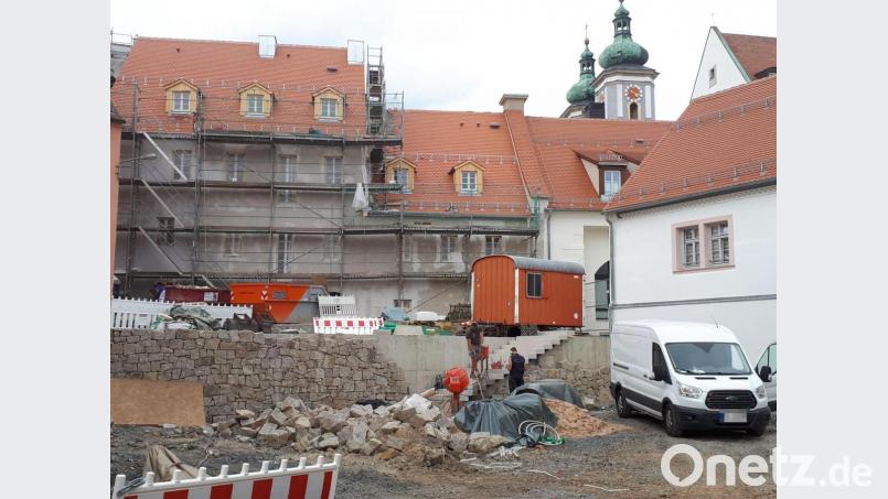 Schon weit fortgeschritten ist der Bau der Natursteinmauer, die die künftige Parkfläche am neuen Cäcilienplatz im Mühlenviertel begrenzt. Im Hintergrund die Rückseite des Anwesens Brauhausstraße 2. Bild: pz