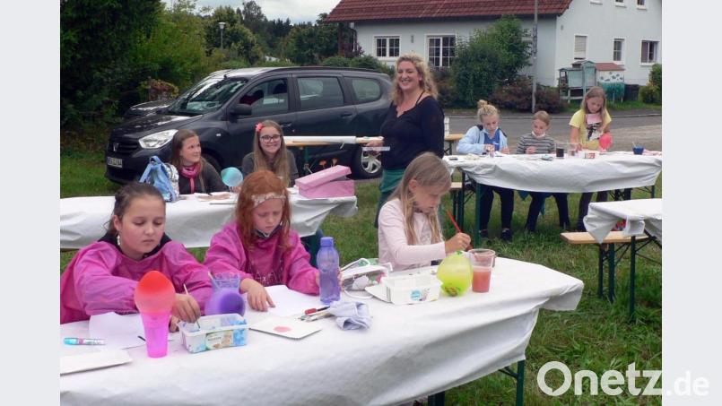 Künstlerin Maria Hertrich (Mitte) zeigt den Mädchen im Ferienprogramm verschiedene Möglichkeiten, um kreativ zu sein. Im Nu werden kleine Kunstwerke geschaffen, die als Grußkarten verwendet werden können. Bild: lep