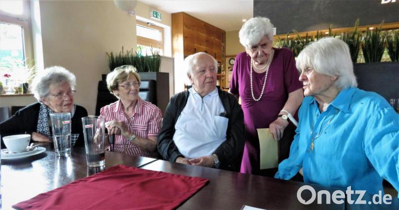 Tilo Fuchs (rechts), geboren in Regensburg und aufgewachsen in Bärnau, verbindet mit den Bärnauer Seniorinnen und Senioren eine aufregende Kindheit und Jugend während und nach dem Zweiten Weltkrieg. In der Gaststätte „Brot &amp; Zeit“ haben die Freunde nun einen Nachmittag lang Erinnerungen ausgetauscht. Im Bild: Irmgard Weiß (stehend) zeigt Tilo Fuchs alte Fotos. Marianne Zwerenz sowie das Ehepaar Hermine und Willibald Wolf (von links) erinnern sich ebenfalls. Bild: ubb