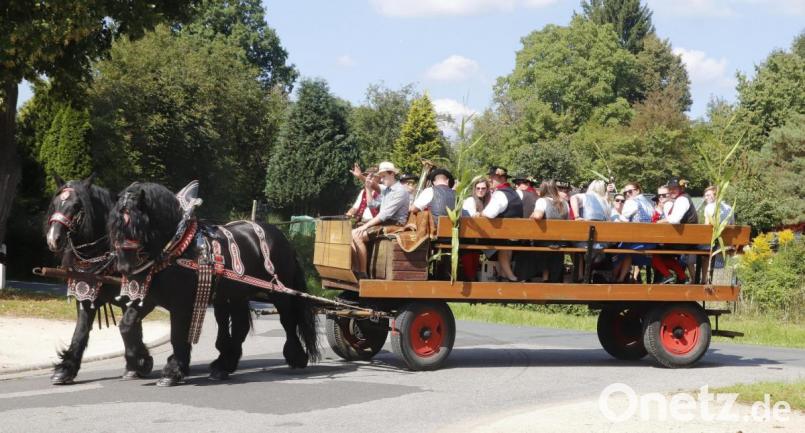Die Rosenberger Kirwaleit lieferten Holztische und -bänke stilecht in Montur und mit einem Pferdegespann aus. Bild: mfh