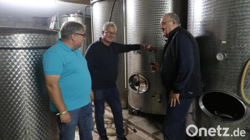 Hier ist er drin. Bürgermeister Willi Schwartz (Mitte) präsentiert Bürgermeister Lothar Höher (rechts) und dem Weidener Sozialdezernenten Wolfgang Hohlmeier seine Weinfässer. Bild: Kunz