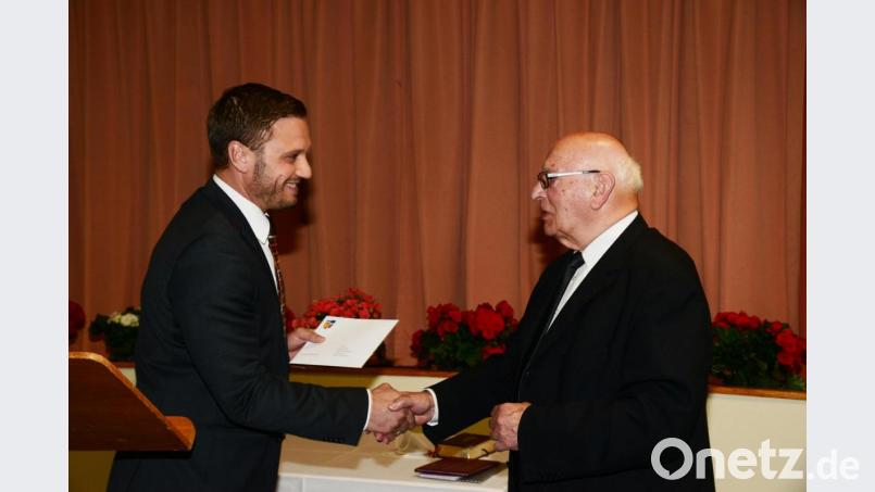 Bürgermeister Ernst Lenk überreicht Pfarrer Andreas Hanauer zu seinem 50-jährigen Priesterjubiläum ein Geldgeschenk für den Kauf einer dritten Glocke für die Kirche St. Jakob in Schirmitz. Bild: bey