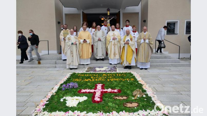 Nach dem Festgottesdienst am Sonntagnachmittag bestaunen Geistlicher Rat Andreas Hanauer und seine Mitbrüder den Blumenteppich vor der Kirche Maria Königin. Bild: bey