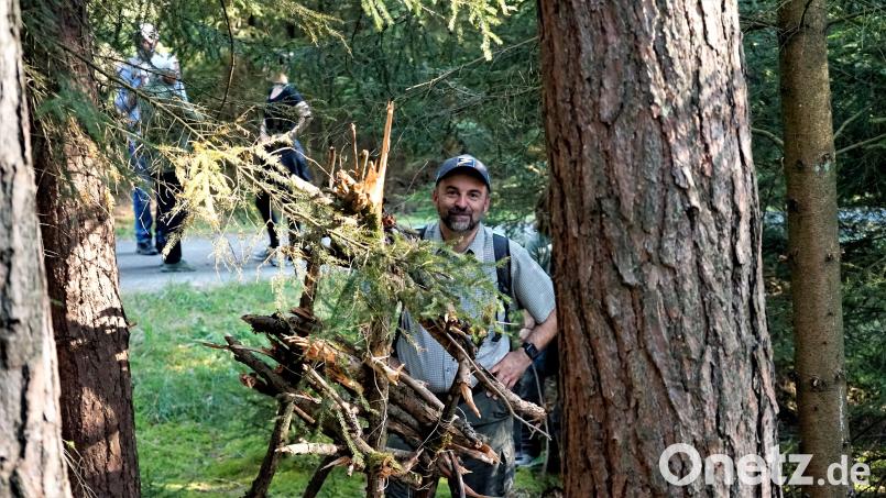 Gästeführer Michael Rückl vor einer der Kunstinstallationen von Christian Eisenberger, der sich dafür bei den natürlichen Materialen im Wald bedient hat. Bild:  Kunstprojekt Badehaus Maiersreuth