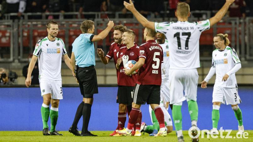 Schiedsrichter Tobias Reichel (Zweiter von links) zeigt Nikola Dovedan (Vierter von links) elf Minuten vor Schluss die Gelb-Rote Karte. Die Nürnberger tobten, die Partie gegen Hannover endete 0:0. Bild: Löb Daniel/dpa
