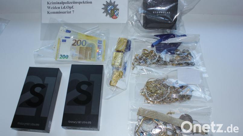 Dies ist ein Teil Beute, die die Polizei sichergestellt hat. Die beiden Smartphones hatte sich der Täter schon von dem gestohlenen Geld gekauft. Bild: Kripo Weiden/exb