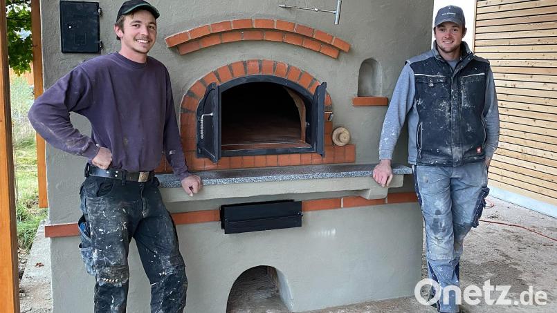 Backofenbauer Matthias Maurer (von rechts) und sein Bruder Jonas errichteten in Krummennaab einen mit Holz befeuerten Hausbackofen. Bild: nza