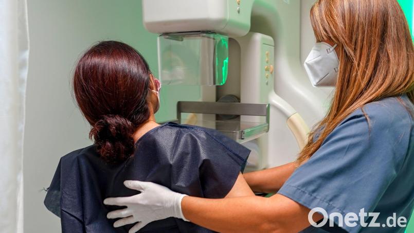 Eine Frau wird mit Hilfe einer Krankenschwester für eine kostenlose Mammographie anlässlich des Internationalen Brustkrebstages vorbereitet. Bild: Eduardo Briones/dpa