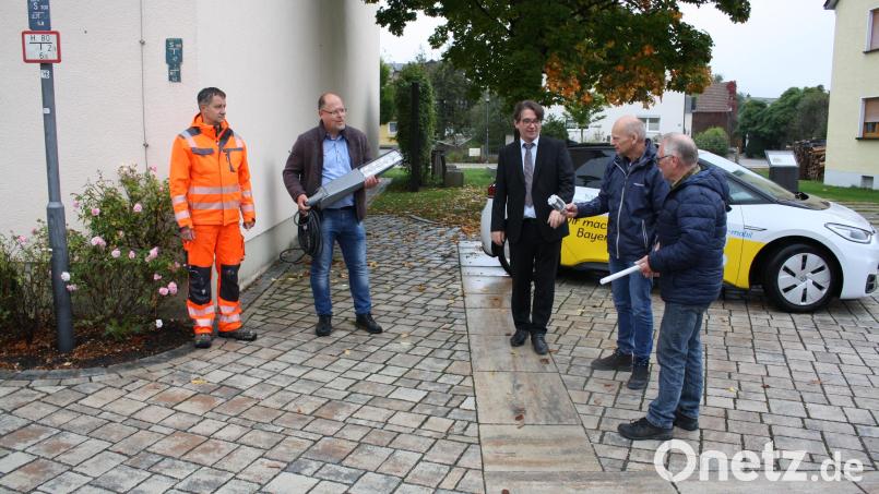 Leuchtstoffröhre ade, willkommen LED: Beim Ortstermin in Schwarzenbach verglichen (von links) Bernd Przetak (Bauhof), Bürgermeister Thorsten Hallmann, Markus Windisch und Gerhard Schmerber vom Bayernwerk sowie Reinhold Sternkopf vom Bauamt der Verwaltungsgemeinschaft Pressath alte und neue Leuchtkörper. Bild: bjp
